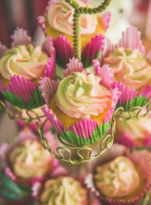 Pink and green cupcakes on a cake stand